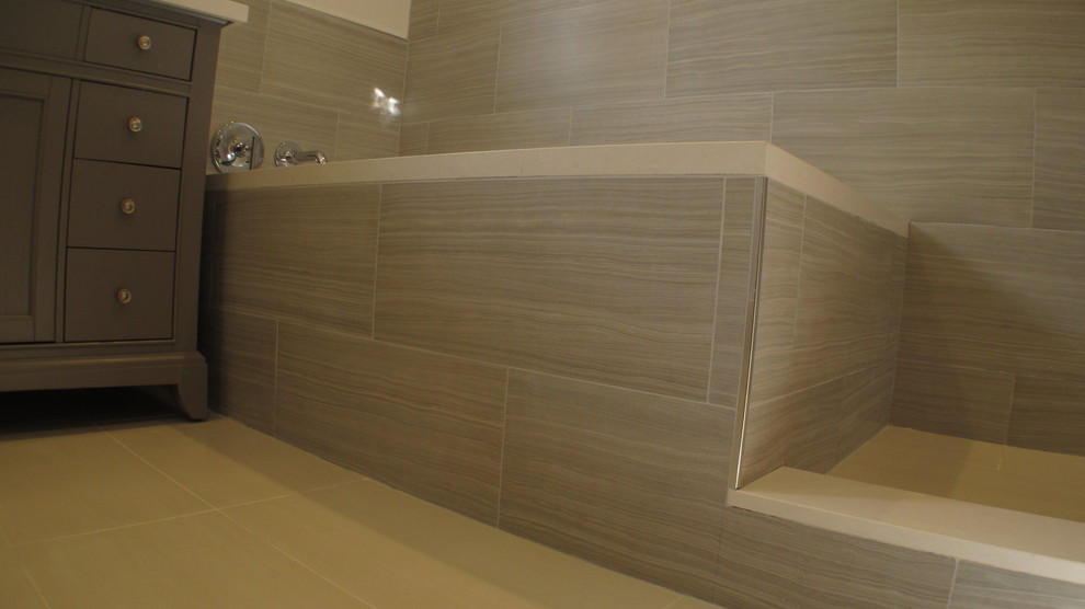 Mid-sized trendy master porcelain tile travertine floor bathroom photo in Los Angeles with furniture-like cabinets, gray cabinets, a two-piece toilet, gray walls, an undermount sink and quartz countertops
