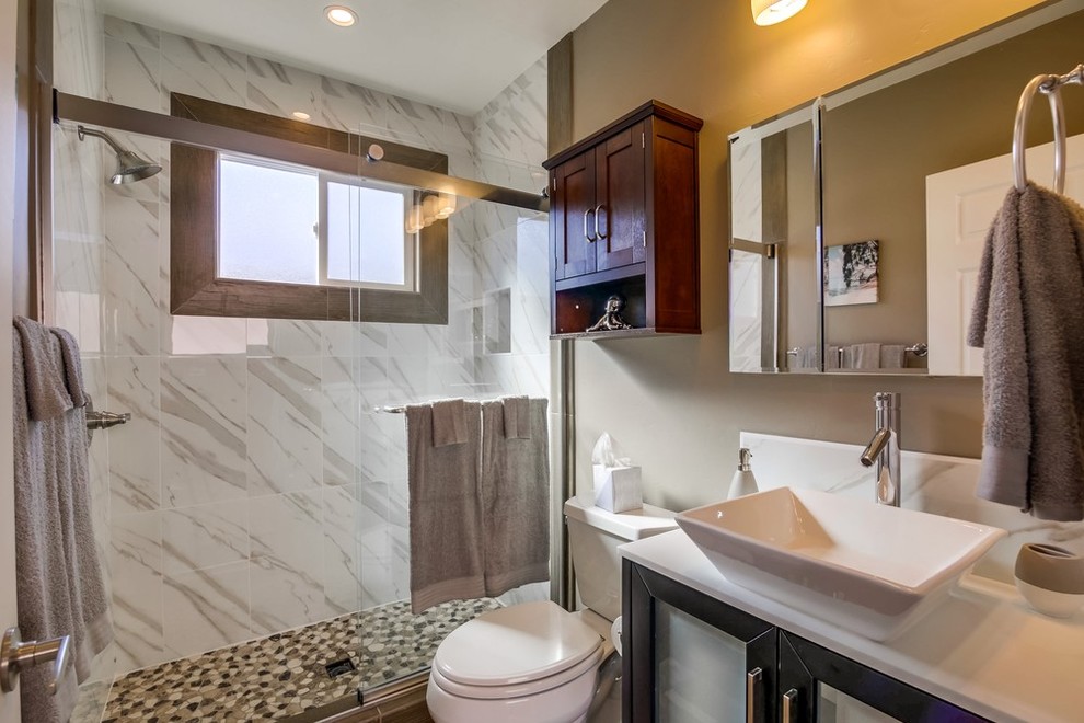 Bathroom - mid-sized traditional master beige tile and porcelain tile porcelain tile and gray floor bathroom idea in Orange County with flat-panel cabinets, medium tone wood cabinets, a two-piece toilet, limestone countertops, a vessel sink and gray walls