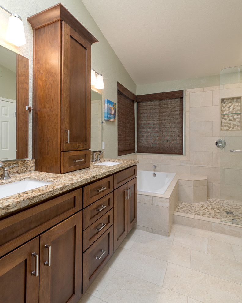 Design ideas for a medium sized traditional ensuite bathroom in San Diego with a submerged sink, raised-panel cabinets, medium wood cabinets, granite worktops, a built-in bath, a walk-in shower, beige tiles, ceramic tiles, beige walls and ceramic flooring.