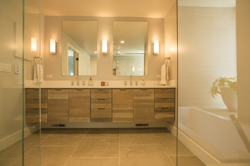 Example of a mid-sized trendy master beige tile and porcelain tile ceramic tile bathroom design in Boston with a drop-in sink, flat-panel cabinets, medium tone wood cabinets, laminate countertops, a one-piece toilet and beige walls