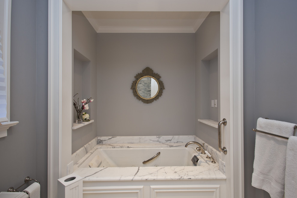 Bathroom - farmhouse bathroom idea in San Francisco with white cabinets and an undermount tub