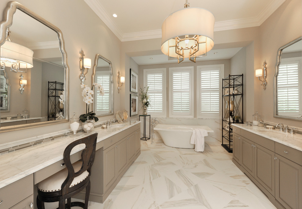 Inspiration for a large mediterranean master white tile and ceramic tile marble floor bathroom remodel in Miami with an undermount sink, raised-panel cabinets, gray cabinets, marble countertops, a two-piece toilet and beige walls