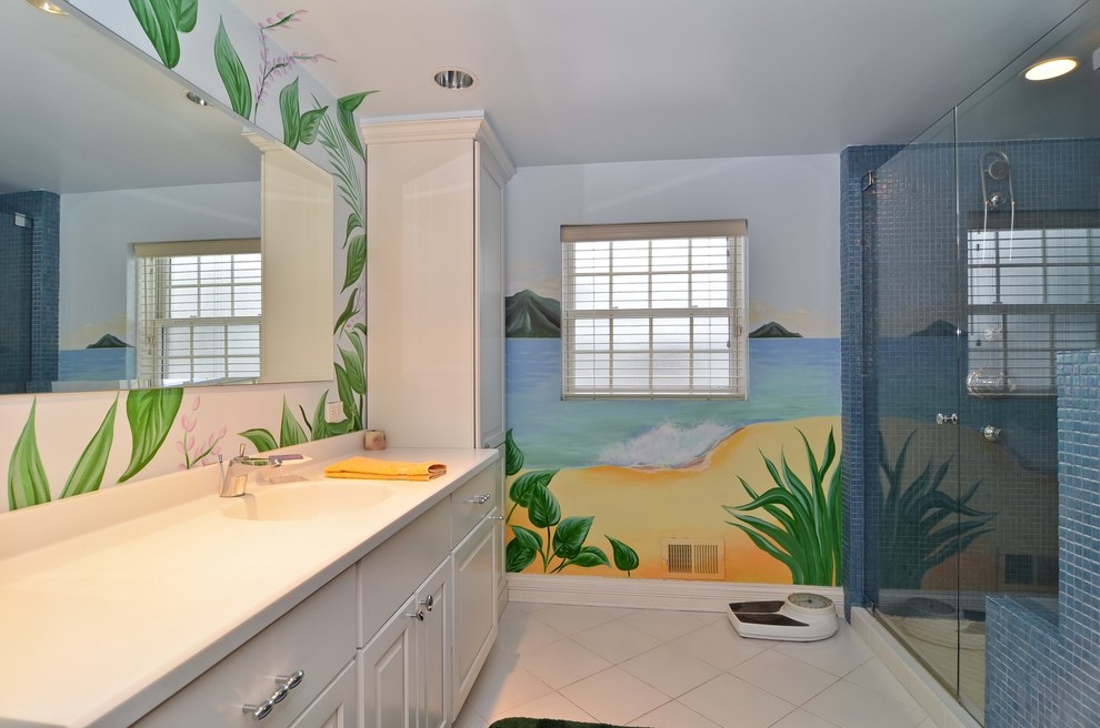 На фото: ванная комната среднего размера в морском стиле с монолитной раковиной, столешницей из искусственного камня, синей плиткой, полом из керамогранита и душевой кабиной с
