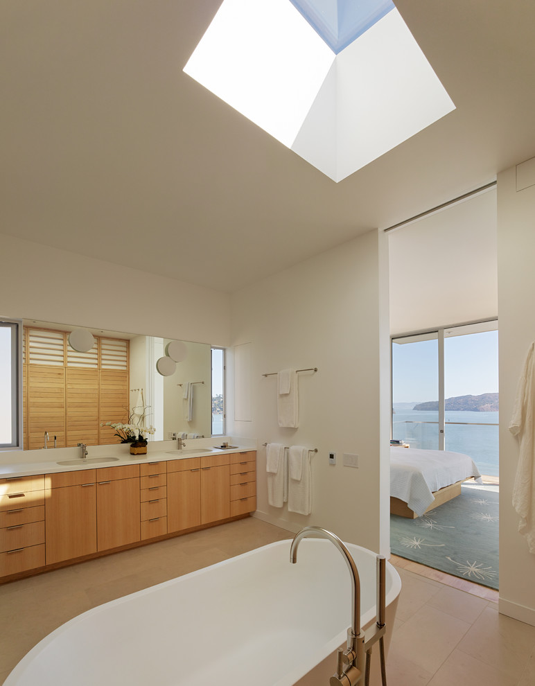 Photo of a contemporary bathroom in San Francisco with flat-panel cabinets, medium wood cabinets and white walls.