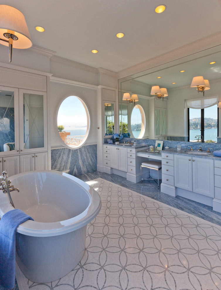 Inspiration for a large nautical ensuite bathroom in San Francisco with recessed-panel cabinets, white cabinets, a freestanding bath, blue tiles, stone slabs, grey walls, a submerged sink, blue floors, mosaic tile flooring, quartz worktops and blue worktops.