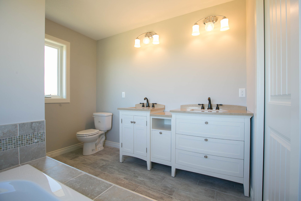 На фото: ванная комната в стиле неоклассика (современная классика) с фасадами островного типа, гидромассажной ванной, открытым душем, плиткой из листового стекла и столешницей из бетона
