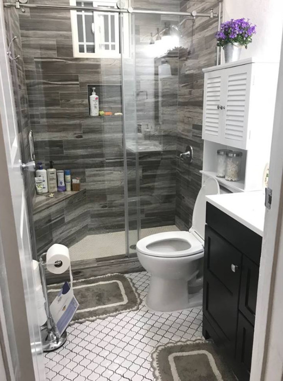 Small trendy 3/4 brown tile and porcelain tile white floor bathroom photo in Los Angeles with shaker cabinets, black cabinets, a one-piece toilet, white walls, quartz countertops, white countertops and an integrated sink