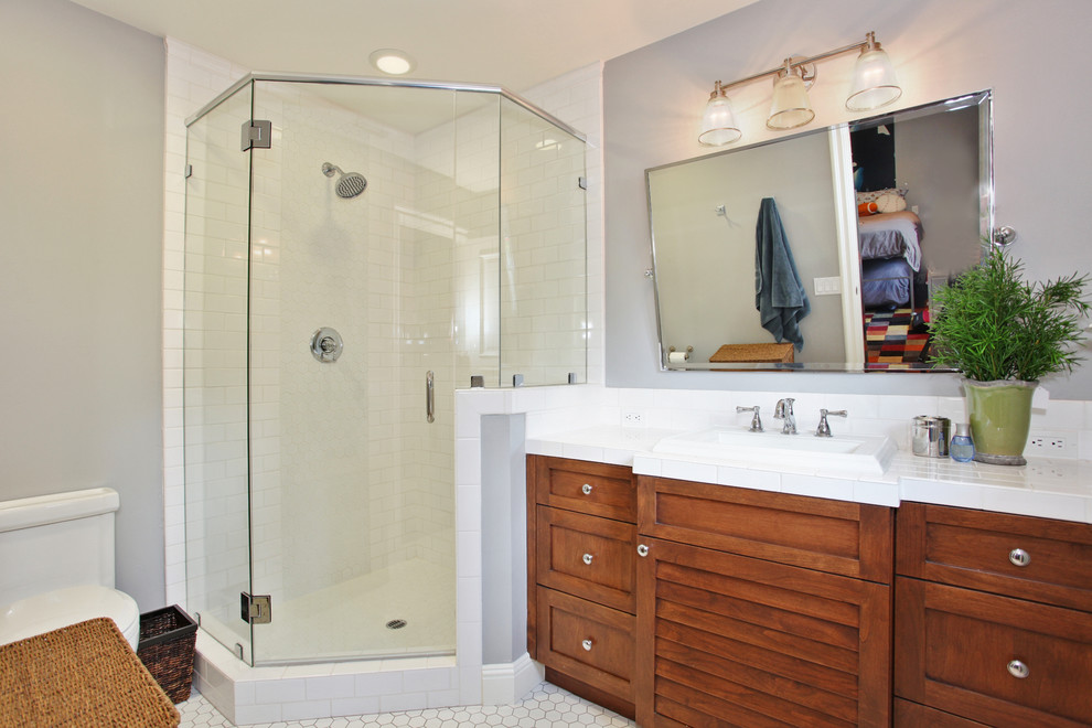 Traditional bathroom in San Diego with a corner shower and feature lighting.