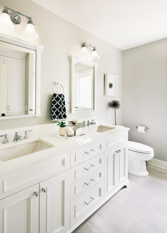 Inspiration for a mid-sized transitional beige floor bathroom remodel in New York with white cabinets and gray walls