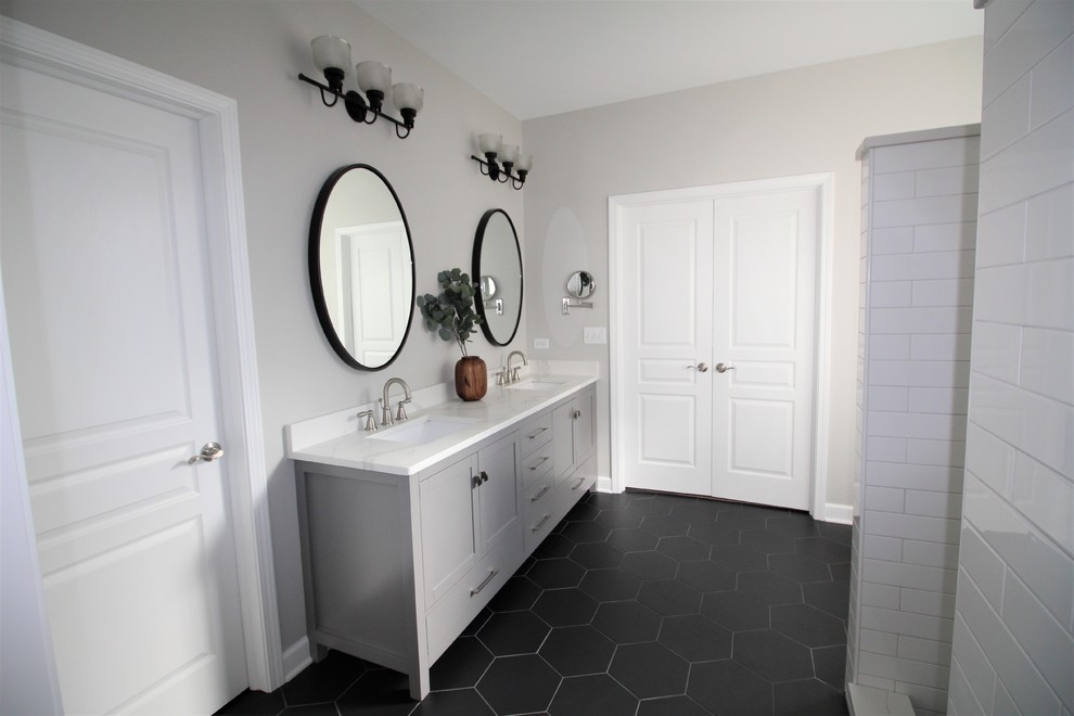 This is an example of a medium sized scandinavian ensuite bathroom in Nashville with shaker cabinets, grey cabinets, white tiles, metro tiles, grey walls, dark hardwood flooring, a submerged sink, quartz worktops, brown floors and white worktops.