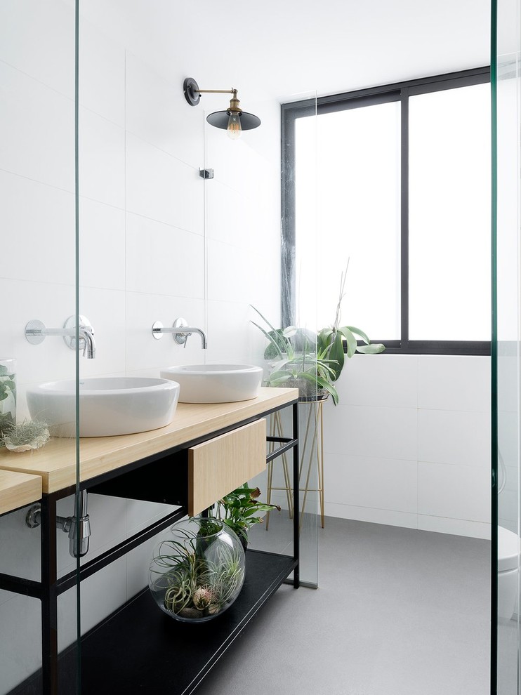 Scandi ensuite bathroom in Tel Aviv with open cabinets, black cabinets, white walls, ceramic flooring, a vessel sink and wooden worktops.