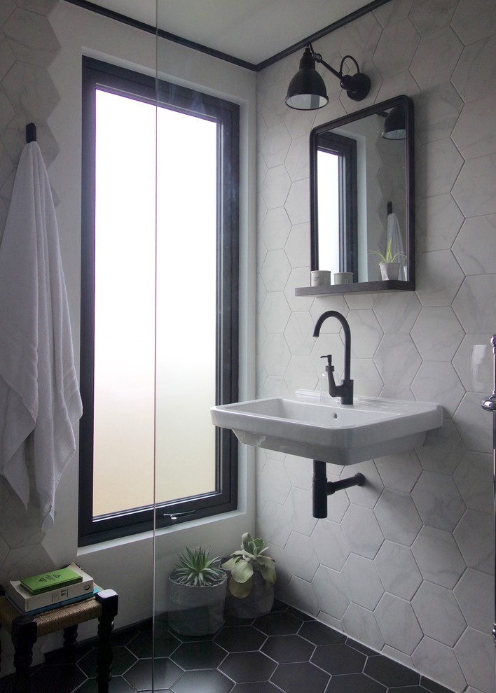Example of a small danish 3/4 black and white tile and porcelain tile porcelain tile doorless shower design in Other with a two-piece toilet, white walls and a wall-mount sink