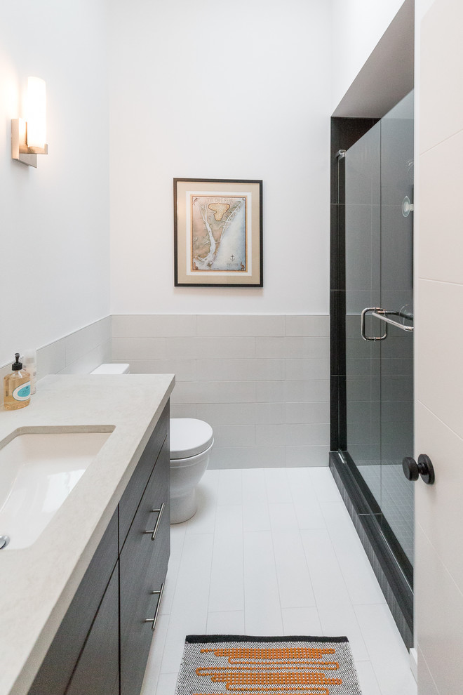 Design ideas for a small modern family bathroom in Wilmington with flat-panel cabinets, dark wood cabinets, an alcove shower, a two-piece toilet, grey tiles, porcelain tiles, white walls, porcelain flooring, a submerged sink, concrete worktops, white floors and a hinged door.