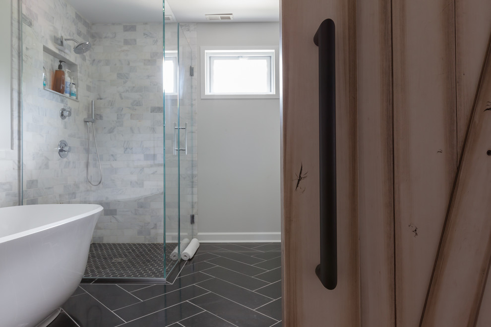 Example of a mid-sized danish master gray tile and marble tile travertine floor and black floor bathroom design in Chicago with shaker cabinets, medium tone wood cabinets, a one-piece toilet, gray walls, an undermount sink, quartz countertops and a hinged shower door