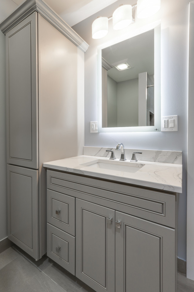 Mid-sized transitional 3/4 gray tile and porcelain tile bathroom photo in Chicago with raised-panel cabinets, gray cabinets, gray walls, an undermount sink and marble countertops