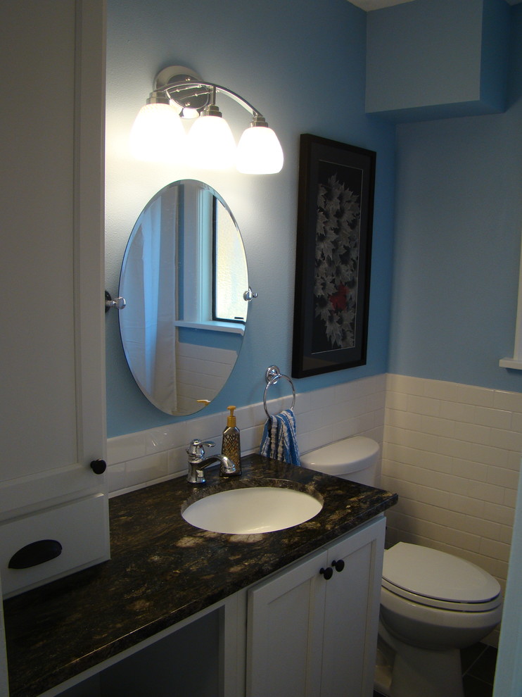 Photo of a traditional bathroom in Seattle with a submerged sink, shaker cabinets, white cabinets, granite worktops, an alcove bath, a shower/bath combination, a two-piece toilet, white tiles and metro tiles.