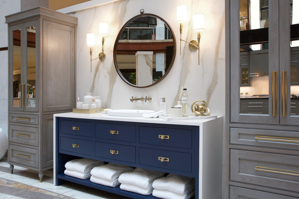 Photo of a medium sized contemporary ensuite bathroom in Atlanta with blue cabinets, a freestanding bath, a built-in shower, multi-coloured tiles, porcelain tiles, a built-in sink, quartz worktops, white worktops and flat-panel cabinets.