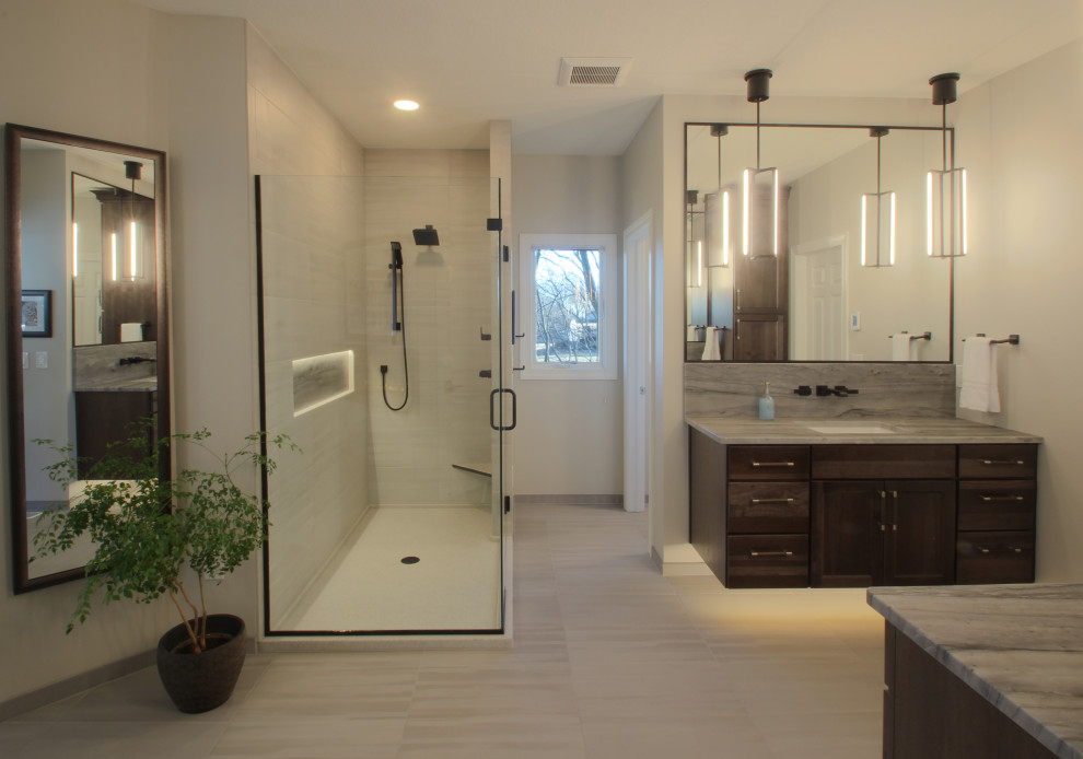 Expansive classic ensuite bathroom in Other with shaker cabinets, dark wood cabinets, a freestanding bath, a corner shower, a one-piece toilet, grey tiles, ceramic tiles, ceramic flooring, a submerged sink, quartz worktops, grey floors, a hinged door, grey worktops, an enclosed toilet, double sinks and a floating vanity unit.