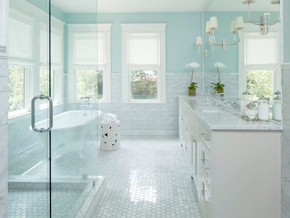 На фото: большая главная ванная комната в стиле неоклассика (современная классика) с фасадами в стиле шейкер, белыми фасадами, ванной на ножках, душем в нише, раздельным унитазом, серой плиткой, белой плиткой, керамогранитной плиткой, синими стенами, полом из мозаичной плитки, врезной раковиной, мраморной столешницей, белым полом и душем с распашными дверями