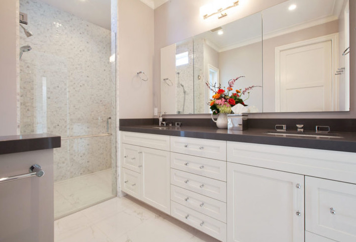 Walk-in shower - mid-sized transitional master mosaic tile marble floor walk-in shower idea in San Francisco with shaker cabinets, white cabinets, beige walls, an undermount sink, solid surface countertops and a hinged shower door