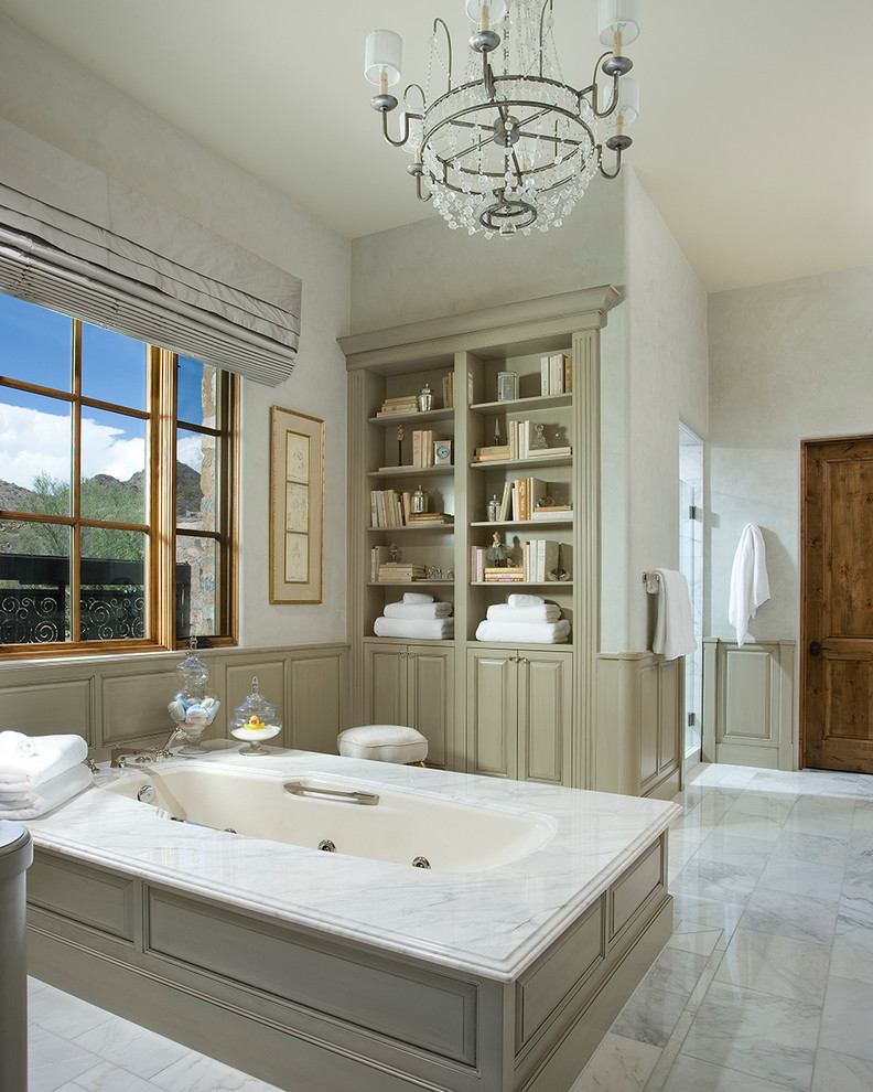 Bathroom - traditional bathroom idea in Phoenix with raised-panel cabinets, gray cabinets, an undermount tub and white walls
