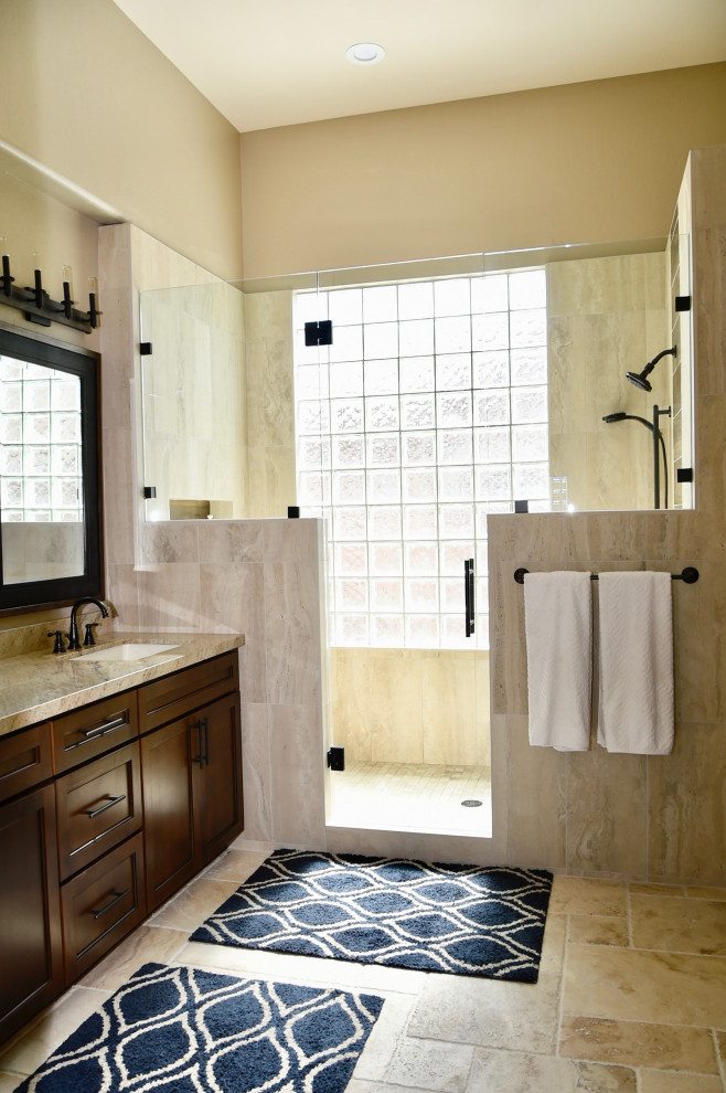 Cette image montre une salle de bain principale design de taille moyenne avec un placard à porte shaker, des portes de placard marrons, un carrelage beige, des carreaux de porcelaine, un mur beige, un sol en travertin, un lavabo encastré, un plan de toilette en granite, un sol beige, une cabine de douche à porte battante, un plan de toilette beige, un banc de douche, meuble double vasque et meuble-lavabo encastré.
