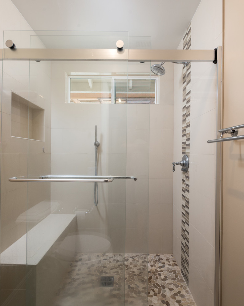 Photo of a large classic ensuite bathroom in San Diego with recessed-panel cabinets, dark wood cabinets, a corner shower, a two-piece toilet, beige tiles, ceramic tiles, beige walls, porcelain flooring, a built-in sink and quartz worktops.