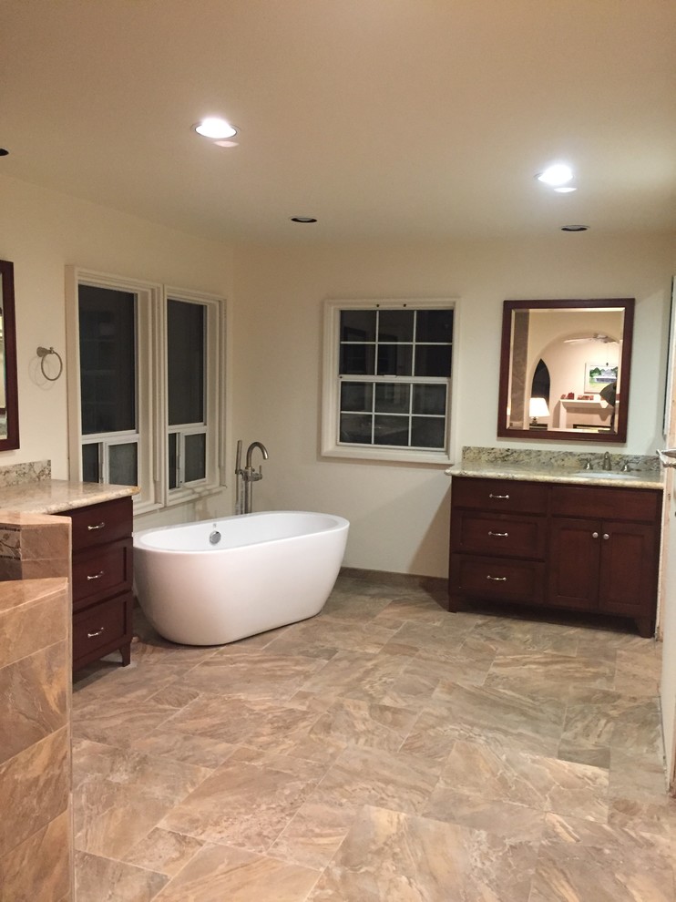 Large tuscan master porcelain tile and beige floor bathroom photo in San Diego with furniture-like cabinets, dark wood cabinets, white walls, an undermount sink, granite countertops, a hinged shower door and multicolored countertops