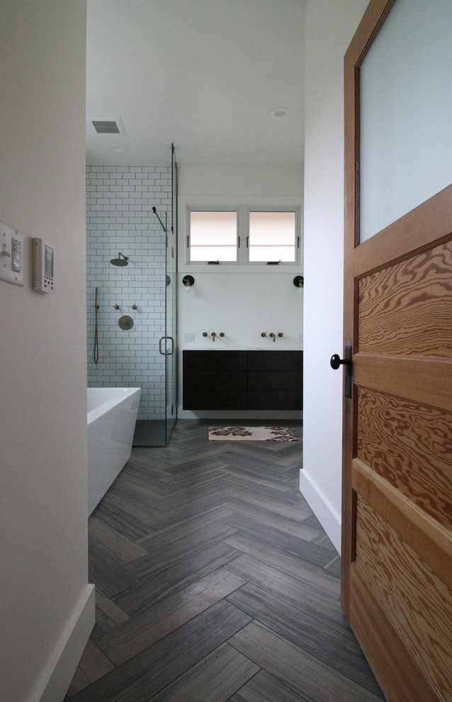 Bathroom - large modern master gray tile and ceramic tile porcelain tile and gray floor bathroom idea in Portland with an undermount sink, flat-panel cabinets, black cabinets, marble countertops, a one-piece toilet, white walls and a hinged shower door
