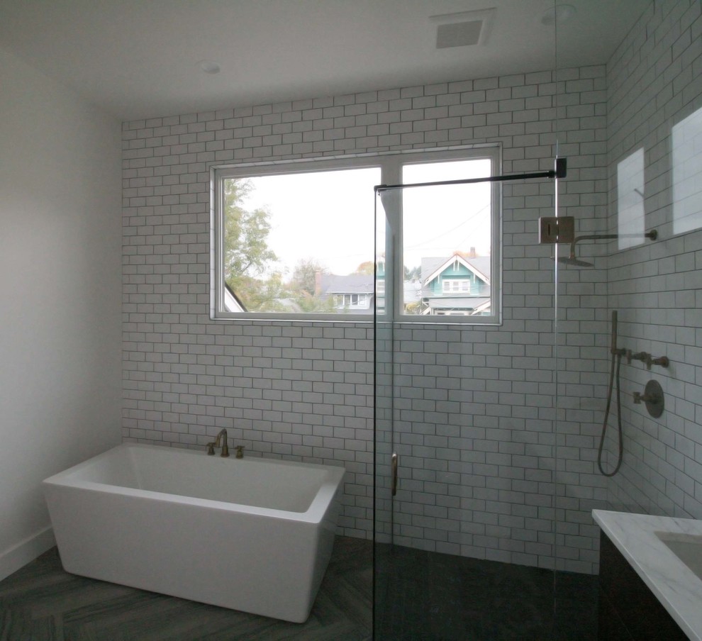 Large modern ensuite bathroom in Portland with a submerged sink, flat-panel cabinets, black cabinets, marble worktops, a japanese bath, a built-in shower, a one-piece toilet, grey tiles, ceramic tiles, white walls, ceramic flooring, grey floors and a hinged door.