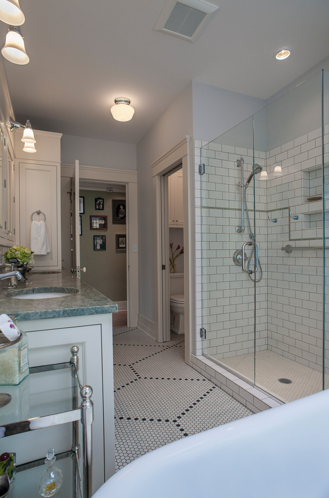 Medium sized classic ensuite bathroom in Portland with a submerged sink, shaker cabinets, white cabinets, granite worktops, a freestanding bath, a double shower, white tiles, metro tiles, grey walls and mosaic tile flooring.