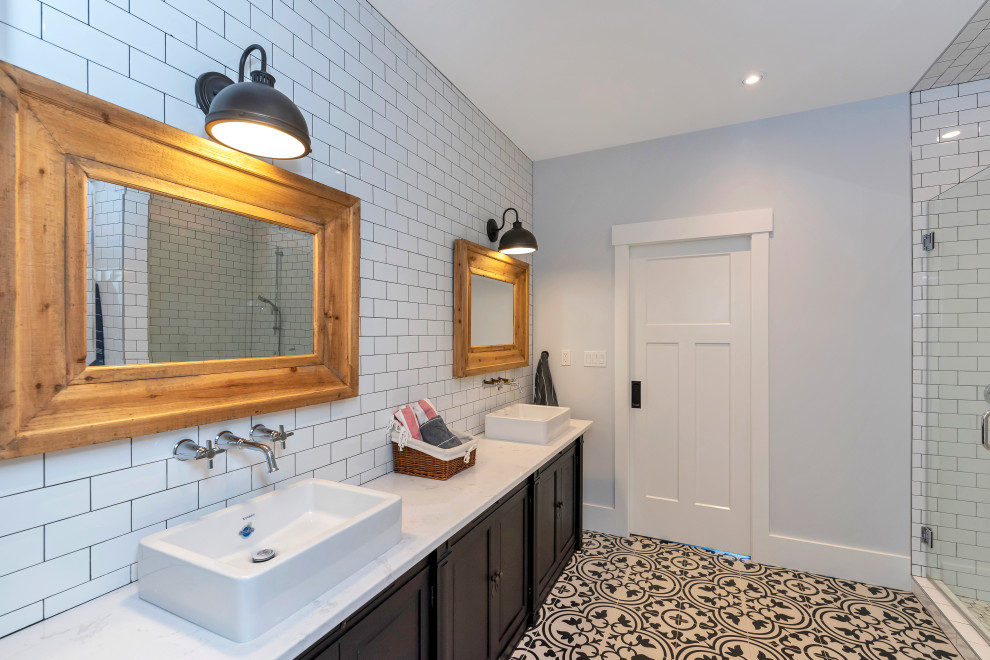 Inspiration for a mid-sized country kids' white tile and subway tile multicolored floor and ceramic tile double shower remodel in Vancouver with blue walls, white countertops, furniture-like cabinets, black cabinets, a one-piece toilet, a vessel sink, quartz countertops and a hinged shower door