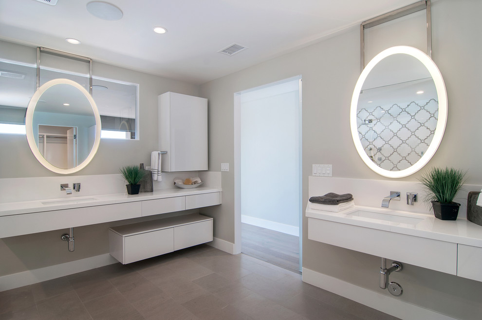 Inspiration for a large contemporary ensuite bathroom in San Diego with flat-panel cabinets, white cabinets, a freestanding bath, a walk-in shower, a one-piece toilet, white tiles, mosaic tiles, grey walls, limestone flooring, a submerged sink and marble worktops.