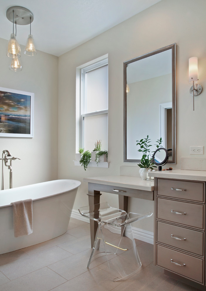 Bathroom - mid-sized transitional master stone tile beige floor and ceramic tile bathroom idea in Orange County with gray cabinets, quartz countertops, a two-piece toilet, beige walls, a hinged shower door, recessed-panel cabinets and a drop-in sink