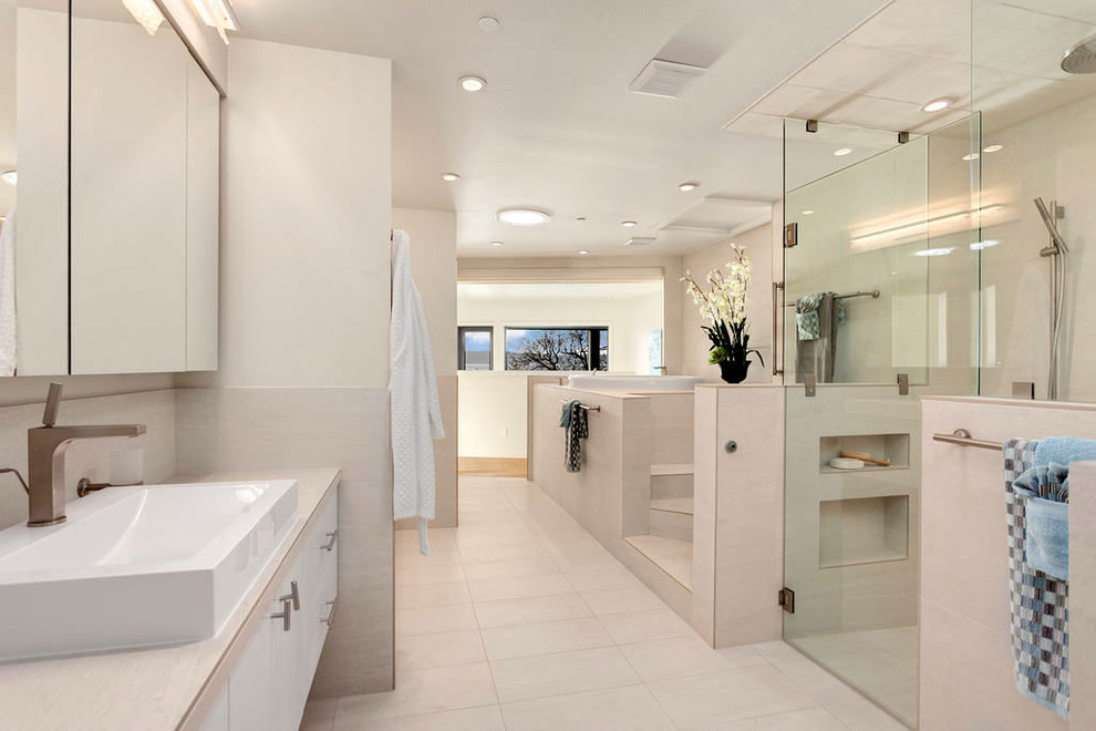 Design ideas for a large modern ensuite bathroom in Seattle with flat-panel cabinets, white cabinets, a built-in bath, a built-in shower, a one-piece toilet, white tiles, porcelain tiles, white walls, porcelain flooring, a vessel sink, tiled worktops, white floors, a hinged door, white worktops, double sinks and a floating vanity unit.