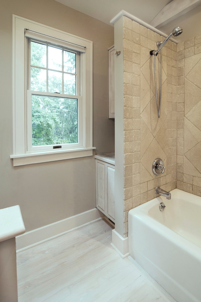 Medium sized classic bathroom in Detroit with raised-panel cabinets, light wood cabinets, an alcove bath, a shower/bath combination, a one-piece toilet, grey tiles, marble tiles, grey walls, light hardwood flooring, a console sink, white floors and a shower curtain.