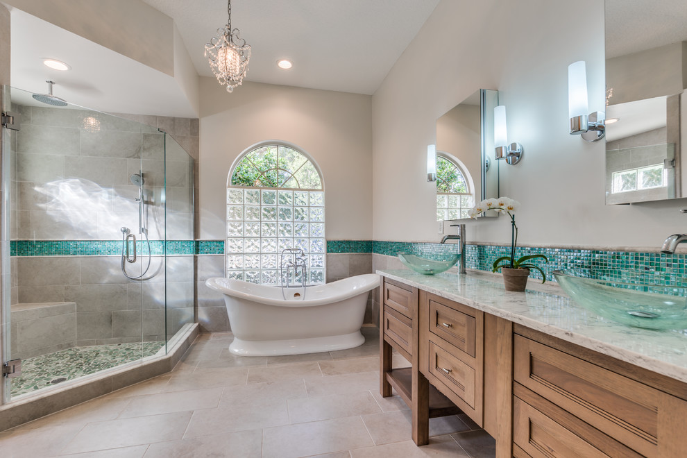 Inspiration for a mid-sized transitional master gray tile and glass tile porcelain tile bathroom remodel in Jacksonville with furniture-like cabinets, medium tone wood cabinets, white walls, quartz countertops, a vessel sink and a two-piece toilet
