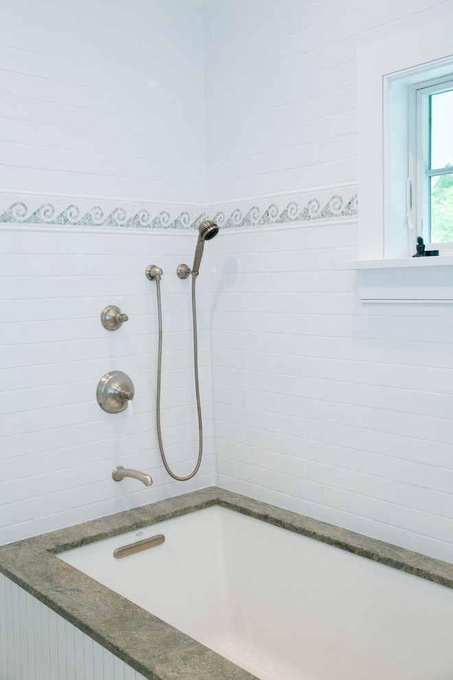 Photo of a nautical ensuite bathroom in Boston with granite worktops, a submerged bath, white tiles and metro tiles.