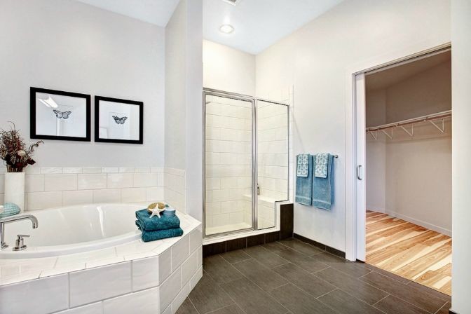 Photo of a large contemporary ensuite bathroom in Seattle with a corner bath, a corner shower, white tiles, ceramic tiles and white walls.
