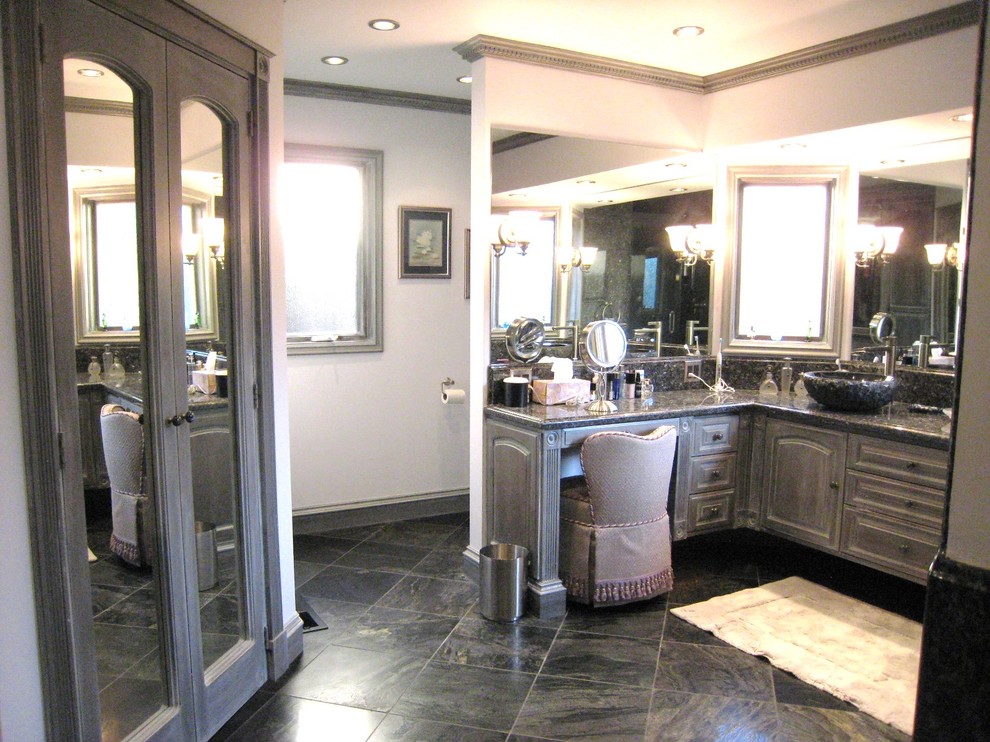 Double shower - large traditional master gray tile and stone slab slate floor double shower idea in Sacramento with a vessel sink, raised-panel cabinets, distressed cabinets, granite countertops, a one-piece toilet and white walls