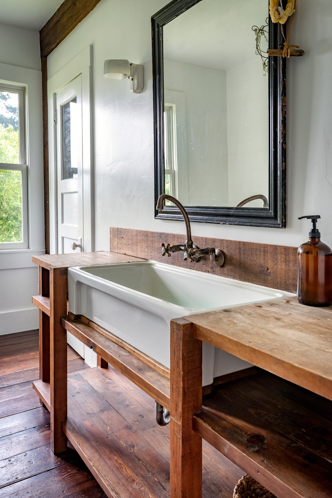 This is an example of a farmhouse bathroom in San Francisco with open cabinets, medium wood cabinets, white walls, dark hardwood flooring, wooden worktops, brown floors and brown worktops.