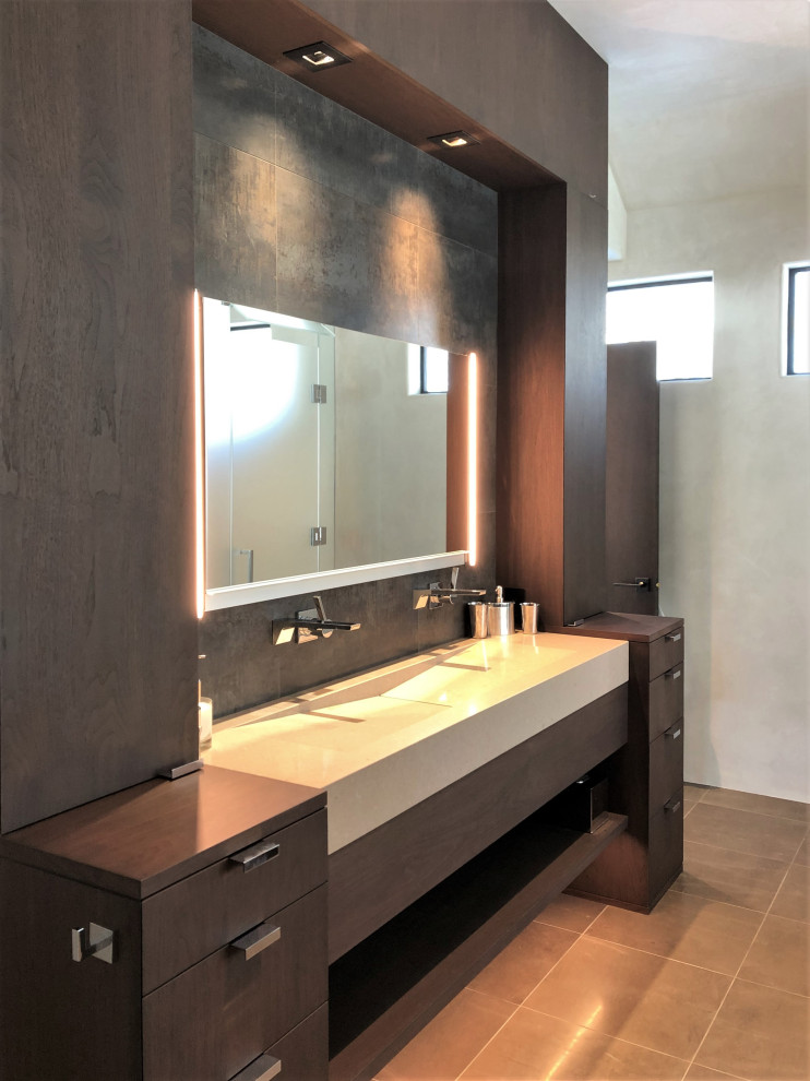 Example of a mid-sized trendy master gray tile brown floor and double-sink bathroom design in Other with flat-panel cabinets, dark wood cabinets, beige walls, a trough sink, a hinged shower door, beige countertops and a built-in vanity