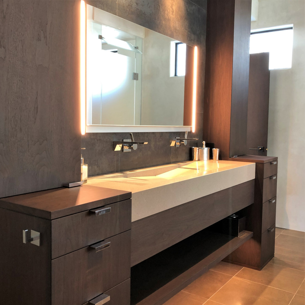 Mid-sized trendy master gray tile brown floor and double-sink bathroom photo in Other with flat-panel cabinets, dark wood cabinets, beige walls, a trough sink, a hinged shower door, beige countertops and a built-in vanity