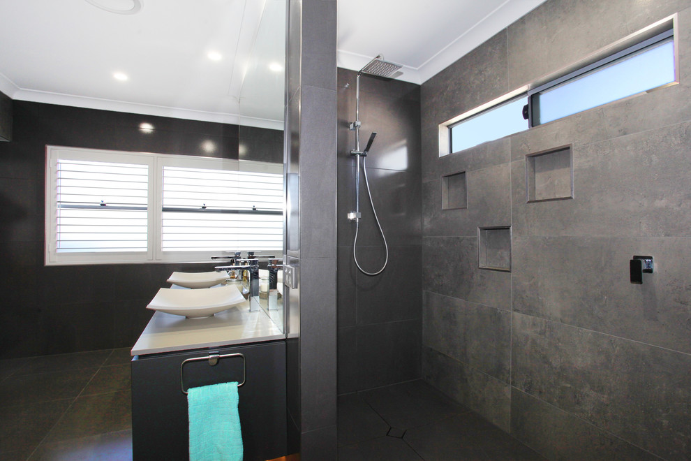 Medium sized modern ensuite bathroom in Sunshine Coast with grey cabinets, a double shower, grey tiles, porcelain tiles, grey walls, porcelain flooring, a vessel sink and engineered stone worktops.