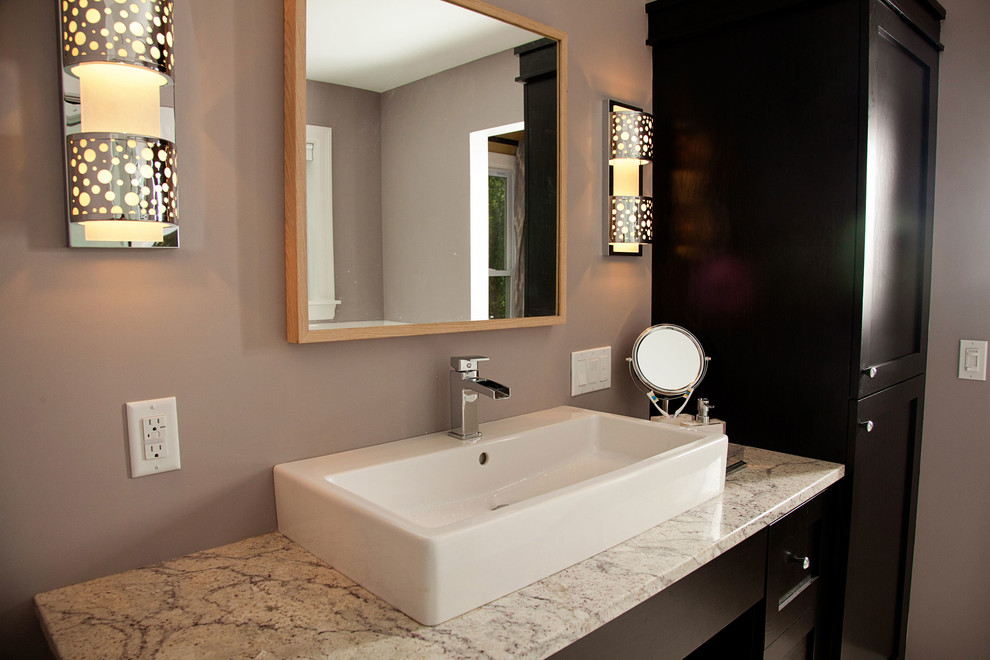 Medium sized contemporary ensuite bathroom in Minneapolis with shaker cabinets, dark wood cabinets, a freestanding bath, a corner shower, a one-piece toilet, white tiles, ceramic tiles, grey walls, ceramic flooring, a trough sink and granite worktops.
