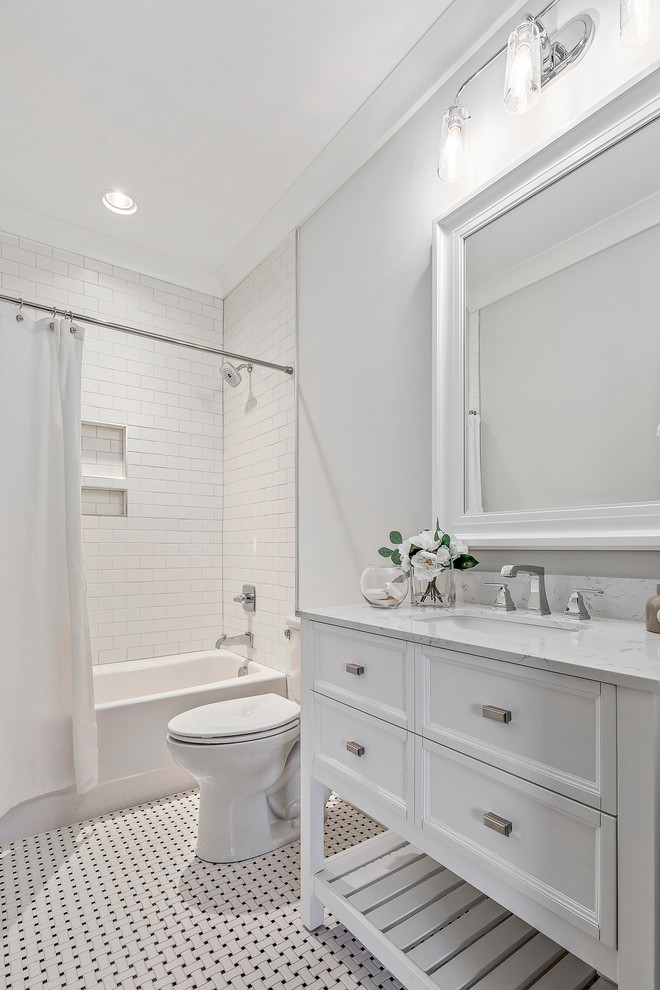 Inspiration for a medium sized country family bathroom in Charlotte with a shower/bath combination, a two-piece toilet, white tiles, metro tiles, beige walls, mosaic tile flooring, a shower curtain and white worktops.