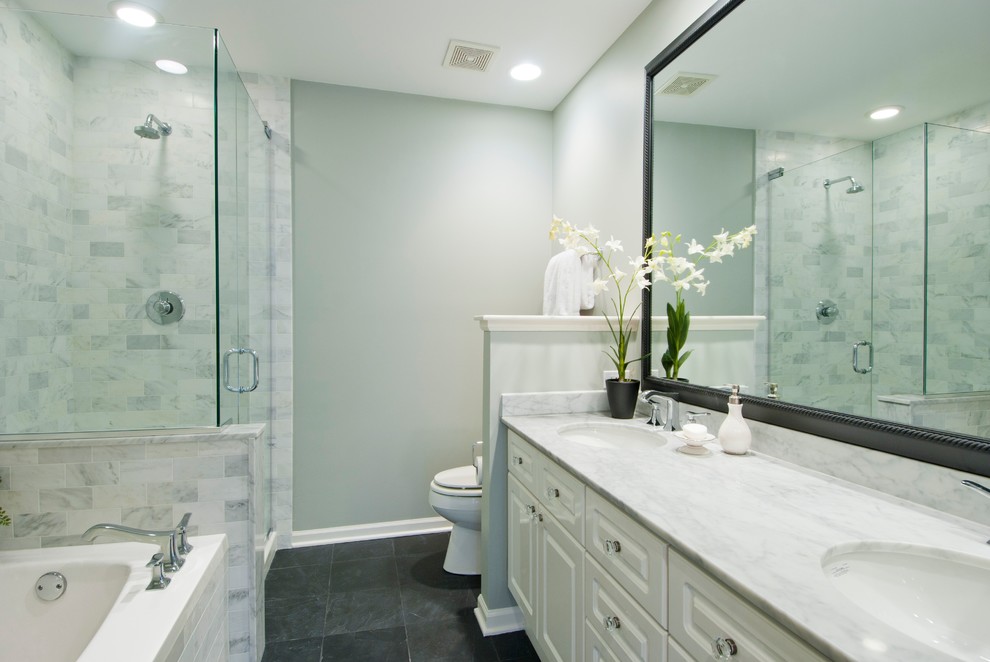 Inspiration for a mid-sized transitional master white tile and stone tile slate floor bathroom remodel in Chicago with an undermount sink, raised-panel cabinets, white cabinets, marble countertops, a two-piece toilet and gray walls