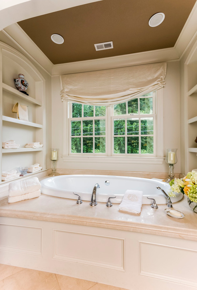 Example of a large classic master beige tile drop-in bathtub design in Charlotte with open cabinets, beige cabinets and beige walls