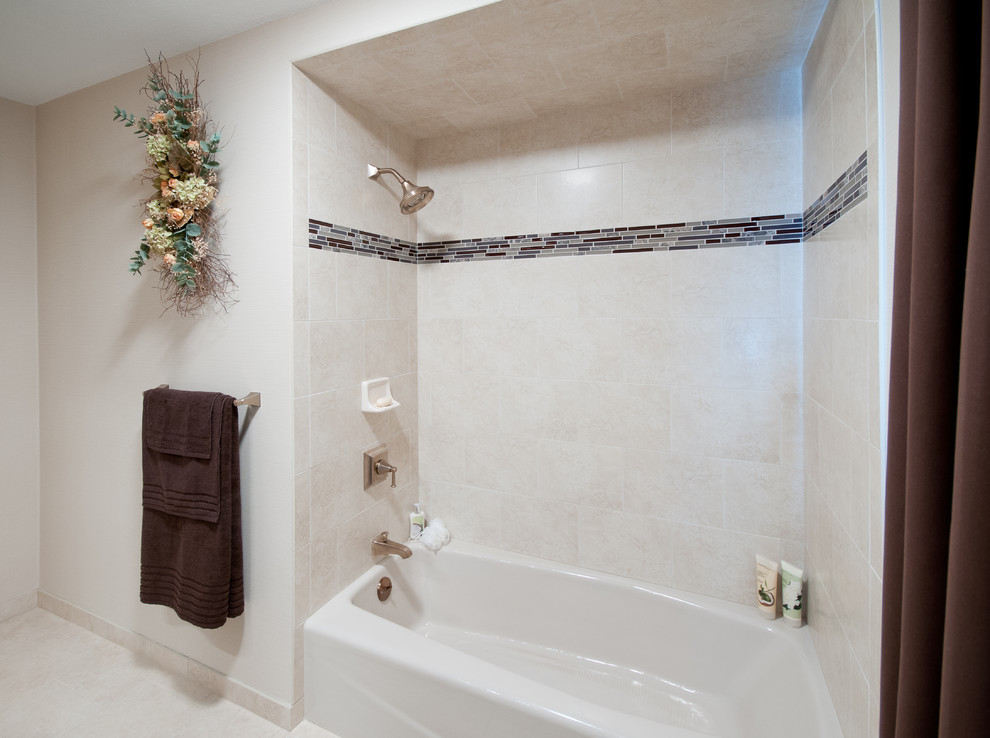 Inspiration for a mid-sized timeless beige tile and porcelain tile porcelain tile bathroom remodel in Providence with raised-panel cabinets, medium tone wood cabinets, marble countertops, a two-piece toilet, an undermount sink and beige walls