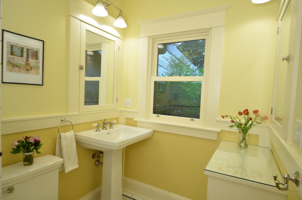 Стильный дизайн: маленькая ванная комната в стиле кантри с фасадами с декоративным кантом, белыми фасадами, раздельным унитазом, черно-белой плиткой, керамической плиткой, желтыми стенами, полом из керамической плитки, раковиной с пьедесталом и стеклянной столешницей для на участке и в саду - последний тренд